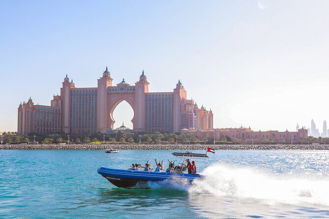 90 Minutes Speedboat Tour: Marina, Atlantis, Palm & Burj Al Arab - Cruising Jumeirah Beach: public shoreline, hotels, and coastal energy