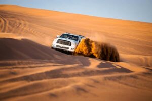 Dubai: Premium Red Dune Safari with Sandboarding & BBQ - From hotel pickup to desert drive: why the first hour matters