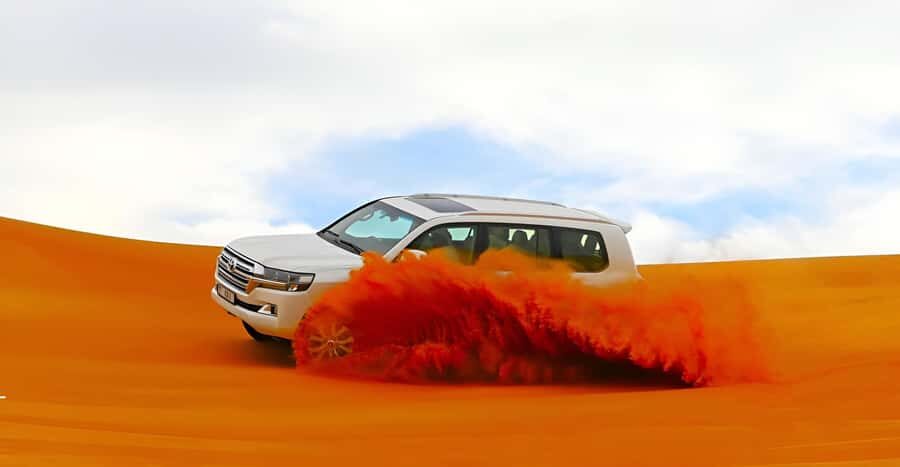 Dubai: Tour with BBQ Dinner, Camel Ride, & Traditional Show - From pickup to dune camp: how the evening flows